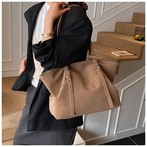 Détail du grand sac cabas vintage en cuir marron avec boucle en métal et bandoulière