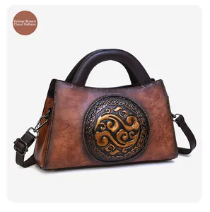 Close-up of yellow-brown leather bag featuring embossed auspicious cloud patterns