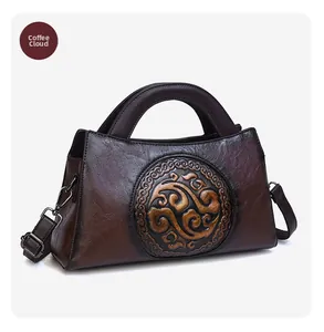 Close-up of vintage brown leather bag featuring an embossed auspicious cloud pattern