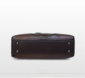 Macro detail of high-quality brown leather bag base featuring durable metal protective studs