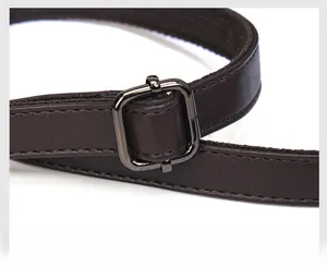 Detailed close-up of a dark brown soft leather shoulder strap with adjustable buckle