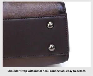 Detail of detachable shoulder strap hook on vintage embossed brown leather bag