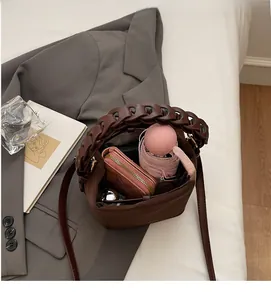 Top-down view of brown PU leather bucket bag interior showing spacious daily storage