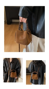 Detail of brown litchi pattern PU leather bucket bag with woven handle and drawstring