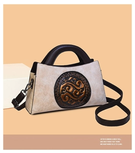 Detail view of retro Chinese style handbag with embossed leather cloud pattern