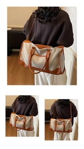Large cream canvas tote with brown leather accents shown in a lifestyle indoor setting