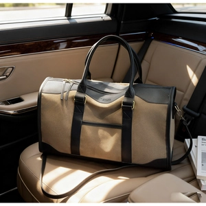 Detail of contrast canvas duffle bag with leather trim on a luxury car seat