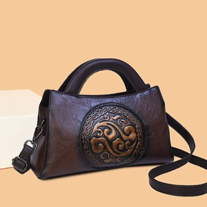 Retro dark brown leather handbag with vintage embossed patterns and round handle