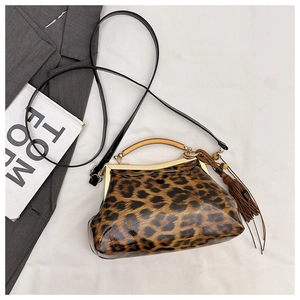 Vue détaillée du sac léopard avec poignée en bois et pompon en cuir élégant de luxe