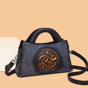Retro embossed leather handbag with ethnic pattern and adjustable brown strap