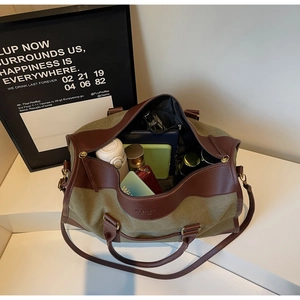 Detail of olive green canvas tote interior showing spacious storage and leather trim
