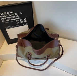 Detail view of large canvas tote bag showing spacious interior and contrast leather trim