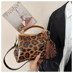 Détail du sac en cuir verni imprimé léopard avec poignée en bois et ferrures dorées