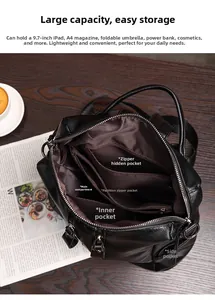 Detailed view of black soft leather backpack interior compartments and functional pockets