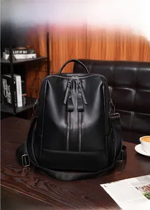 Close-up of black lychee grain faux leather backpack with vertical double zippers and handle