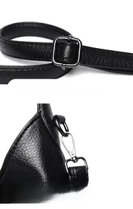 Detail of adjustable shoulder strap with silver lobster clasp on black lychee leather bag