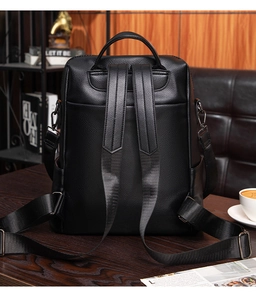 Close-up of litchi grain black leather backpack with adjustable straps and metal hooks