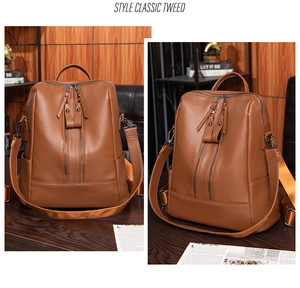 Detail view of brown soft leather backpack with vertical zippers and side pockets