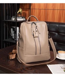 Detail of soft khaki pebbled leather backpack with double vertical zippers and side pockets
