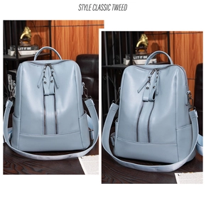 Detail view of light blue soft leather backpack with double vertical zipper design