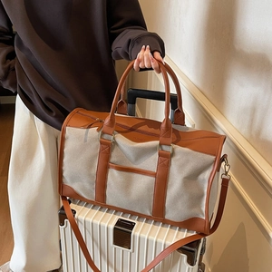 Large contrast color canvas tote bag for commuting with brown leather trim and shoulder strap