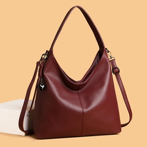 Minimalist burgundy hobo shoulder bag with litchi texture and heart charm detail