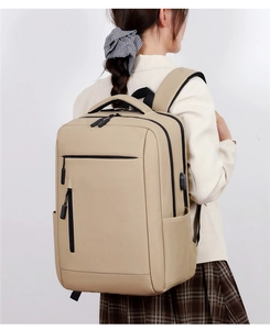 Detail of beige commuter laptop backpack with USB charging port shown from side view