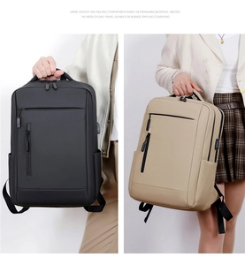 Close-up of business backpacks in black and khaki showing spacious multi-layer design
