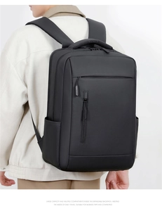 Rear view of a man wearing a large capacity black waterproof business laptop backpack