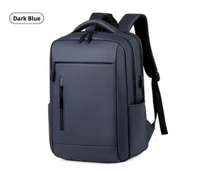 Detail of dark blue business backpack showing USB charging port and waterproof fabric