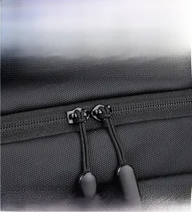 Close-up of smooth double zipper pulls on waterproof business backpack with honeycomb texture