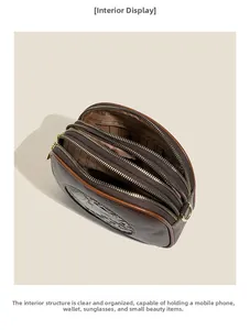 Detailed view of dark brown crossbody bag with triple zipper pockets and organized interior