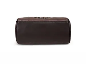 Detailed macro view of the dark brown leather bag base featuring reinforced double stitching