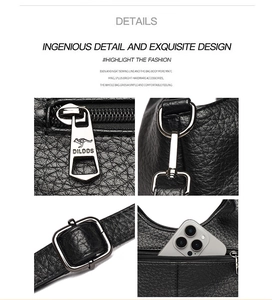 Detail of black pebble leather handbag featuring silver hardware, zippers and phone pocket