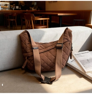 Detail of coffee brown quilted diamond pattern on water-resistant nylon dumpling bag