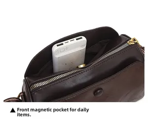 Detail of the front hidden magnetic buckle pocket on this brown embossed leather crossbody bag