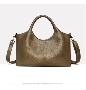 Close-up of olive brown lychee grain leather handbag with stitching and metal buckles
