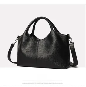 Detail view of high-quality lychee grain leather tote with gunmetal gray hardware accents