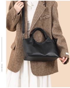 Litchi texture black leather handbag styled with a brown herringbone blazer for a chic look