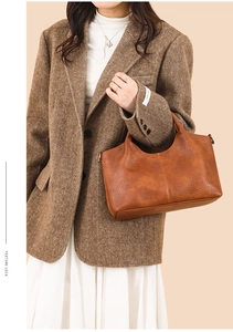 Texture view of caramel pebbled leather tote bag styled with an elegant autumn outfit