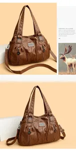 Close-up of brown vintage leather texture and multiple zipper pockets on large tote bag