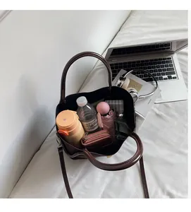 Top view showing large capacity of brown leather bucket bag with daily essentials inside