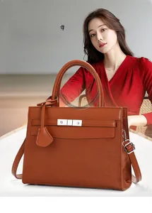 French style brown leather handbag shown with silver hardware and shoulder strap