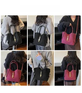 Detailed views of red and black suede bucket bags showing strap and metal clasp design