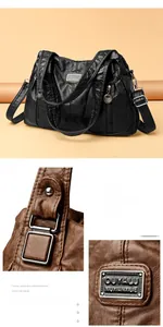 Close-up of textured cowhide leather texture and reinforced metal hardware on handbag