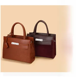 Detail of elegant two-tone leather tote bags with metallic buckles and soft suede panels