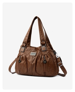 Detail of dark brown faux leather bag with dual zipper pockets and silver hardware