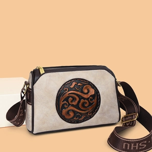 Retro embossed crossbody bag for women featuring creamy white texture and wide shoulder strap