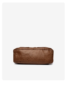 Detail view of the brown vintage leather bag base showing stitching and textured material
