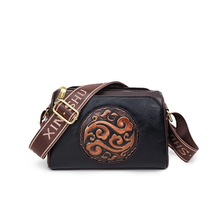 Vintage embossed crossbody bag in black leather with brown cloud pattern and wide strap